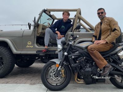 Reza Jarrahy is posing with a bike whereas, Kaiis Steven Jarrahy is posing in a Jeep.
